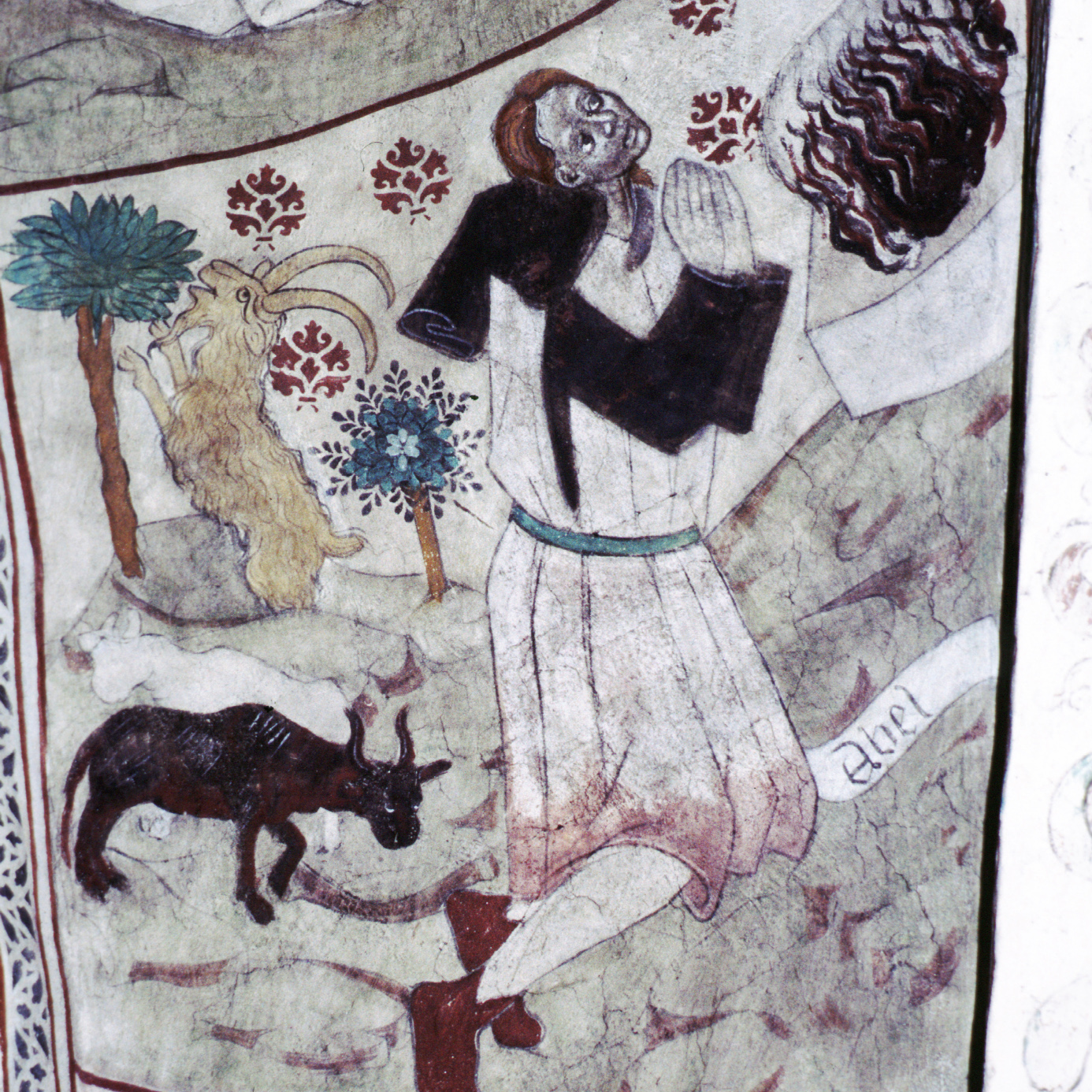 Takmålning från medeltiden i Täby kyrka. Föreställer en man och två offerlam.